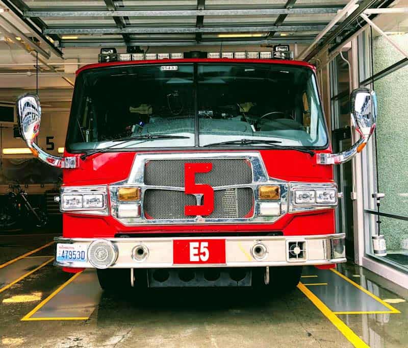 A red fire truck with the number 5 on the grille